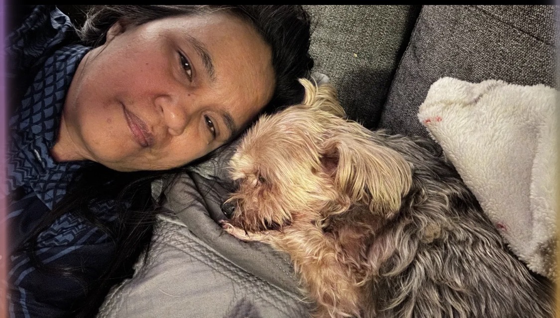 Relaxing with a small fluffy dog